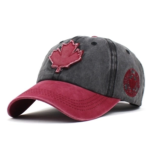 Detail of vintage washed gray baseball cap featuring red maple leaf and Canada side badge