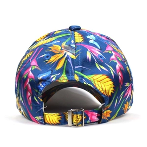 Detail view of the adjustable silver metal buckle on the floral print baseball cap