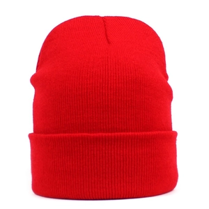 Detailed view of the red ribbed knit beanie with a folded cuff and warm texture