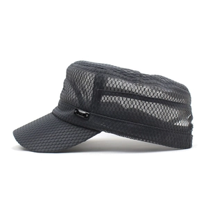 Detail view of the breathable mesh fabric and metal side plaque on the black military cap