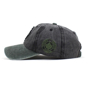 Vintage washed cotton baseball cap with maple leaf embroidery and green brim in side view
