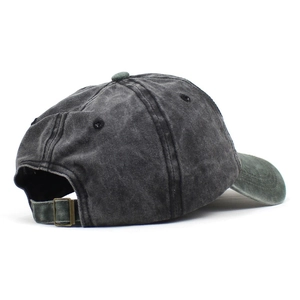 Detail view of adjustable metal buckle and washed vintage cotton texture on baseball cap