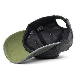 Retro washed cotton baseball cap with green visor and maple leaf patch on white background