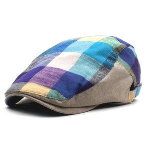 Detail of plaid beret hat showing blue and yellow patterns with khaki panel stitching