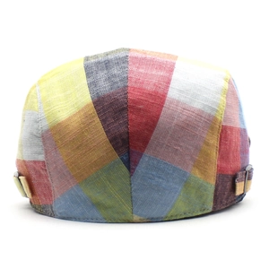 Detail view of colorful plaid pattern and metal adjustment buckle on the vintage flat cap
