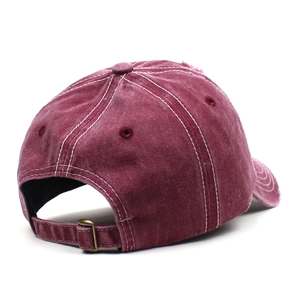 Detail of burgundy washed cotton baseball cap with contrast stitching and metal buckle