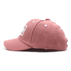 Dettaglio del cappellino da baseball rosa in tela con logo M ricamato in bianco