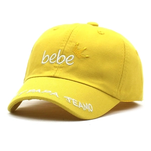 Close-up of a yellow baby baseball cap with crown embroidery and Papa Te Amo text
