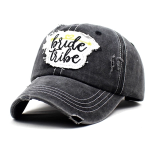 Close-up detail of vintage washed baseball cap with bride tribe embroidery and distressed edges