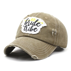 Close-up of washed cotton baseball cap with bride tribe embroidery and distressed details