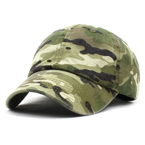 Detailed close-up of woodland camouflage pattern on a cotton curved brim baseball cap