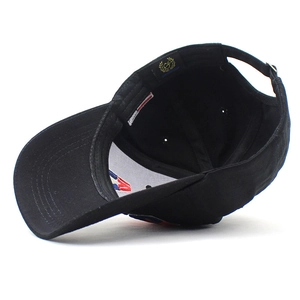 Inside view of black cotton baseball cap showing adjustable strap and reinforced lining