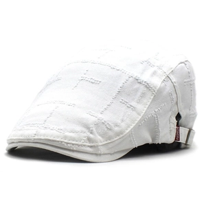 Detail of white cotton flat cap with square stitching and fashion tag on the side