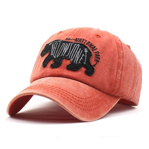 Vintage washed brick red baseball cap featuring Yellowstone National Park bear embroidery