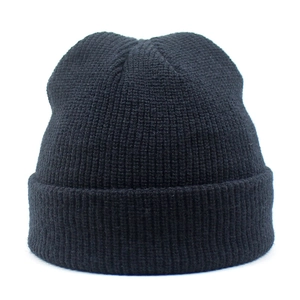 Detailed view of the black ribbed knit beanie showing the premium texture and cuff design