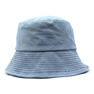 Close-up of light blue denim bucket hat showing cross-hatch texture and parallel stitching