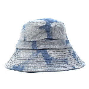 Unisex tie-dye denim bucket hat with wide brim and stitched detailing for sun protection