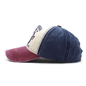 Detail of vintage baseball cap featuring distressed brim and California printed text