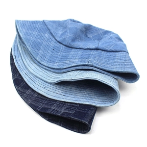 Three variations of blue denim bucket hats featuring plaid textures and sun protection