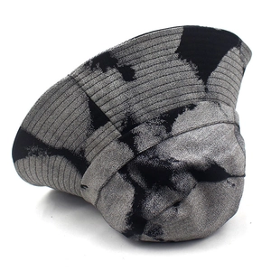 Detail of artistic tie-dye denim bucket hat with metallic texture and ribbed structure