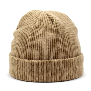 Close-up of khaki knitted beanie with thick wool texture and rolled-up cuff