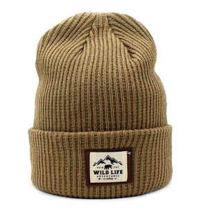 Close-up of khaki ribbed knit beanie featuring a vintage Wild Life adventure patch
