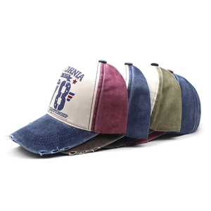 Detailed view of distressed vintage baseball caps in various colors with retro embroidery