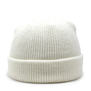 Close-up of white ribbed knit beanie showing thick texture and classic folded cuff