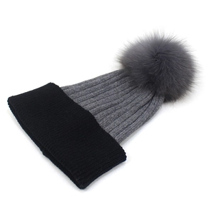 Women's winter ribbed knit beanie in black and gray with large faux fur pom-pom detail