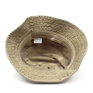 Inside view of khaki cotton bucket hat showing stitching, eyelets and wash label