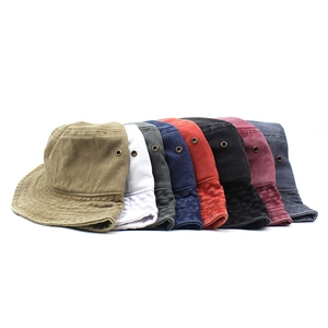 Stack of solid color cotton bucket hats in eight various colors with metal eyelets