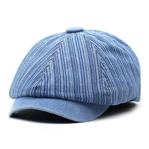 Detail of blue striped denim beret featuring vintage texture and premium cotton fabric