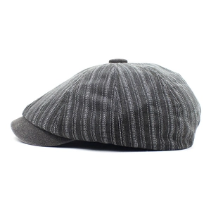 Close-up detail of vintage dark grey striped denim newsboy cap with top button