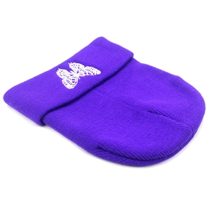 Detailed knit texture of dark purple winter beanie featuring white butterfly embroidery