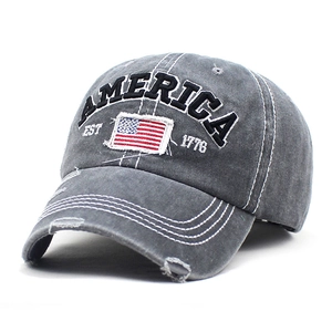Dettaglio del cappellino vintage grigio slavato con ricamo bandiera americana e scritte