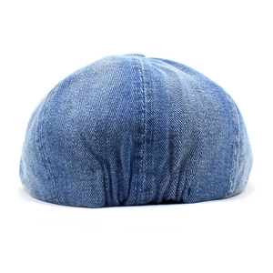 Classic blue denim beret hat with adjustable elastic back detail on white background