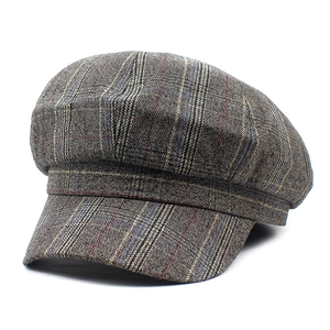 Classic grey and brown plaid newsboy cap with vintage wool texture and curved brim