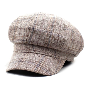 Detailed view of vintage plaid pattern and thick knitted texture on newsboy octagonal hat