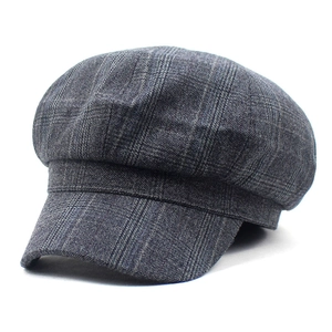 Detailed macro view of retro plaid newsboy cap with dark grey wool texture
