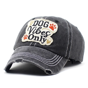 Detail of vintage washed cotton baseball cap with DOG Vibes Only embroidery and distressed brim