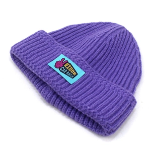 Classic purple ribbed knit beanie for women with blue graphic patch and warm fold-over cuff