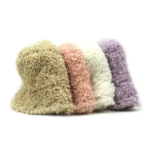 Thick fluffy winter bucket hats in khaki pink and beige with soft faux fur texture