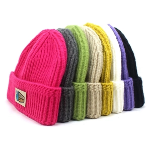 Winter knitted beanie hats in multiple colors with ribbed texture and RIDER patch