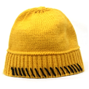 Detail view of bright yellow knitted beanie featuring contrast black stitching and ribbed hem