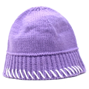 Detailed close-up of purple knit bucket hat with decorative white contrast stitching