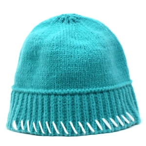 Detail of teal knit bucket hat showing ribbed brim and white hand-stitched accents