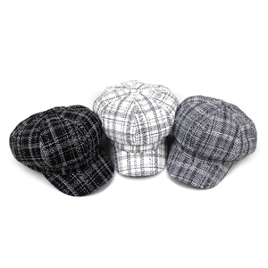 Three retro plaid newsboy hats in black, white and grey tweed textures for autumn fashion