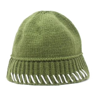 Close-up of army green knit beanie with white contrast stitching detail and thick texture