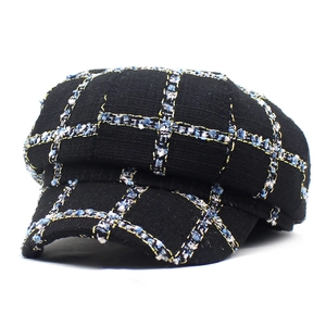 Classic black wool tweed newsboy cap with elegant blue and white plaid pattern for autumn