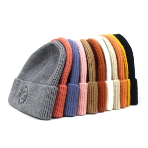 Colorful knitted beanies with embroidered smileys in ten different vibrant colors